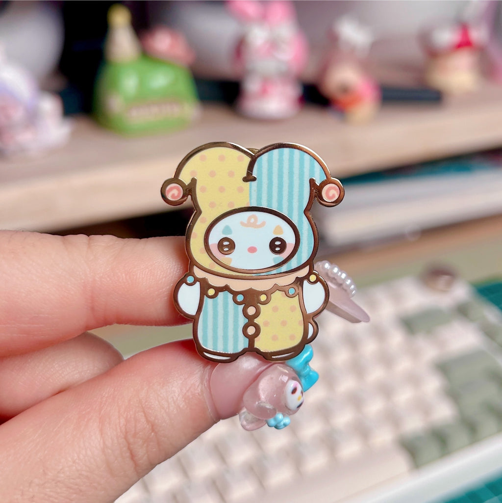 Cartoon character pin held by a hand with a blurred background